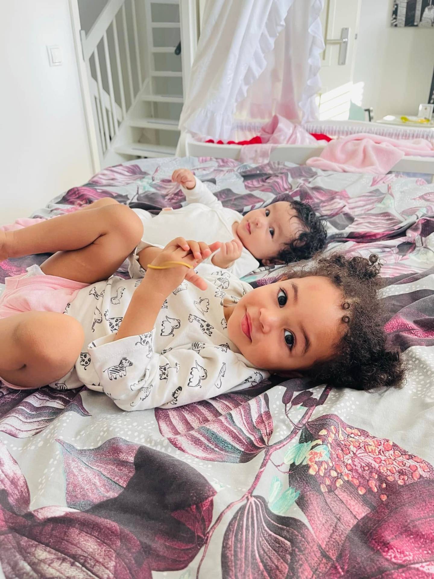 Hope en Faith samen op bed — zusjes, verweven, veilig.